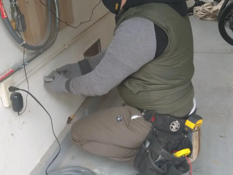 Electrician performing outlet wiring in a San Carlos garage